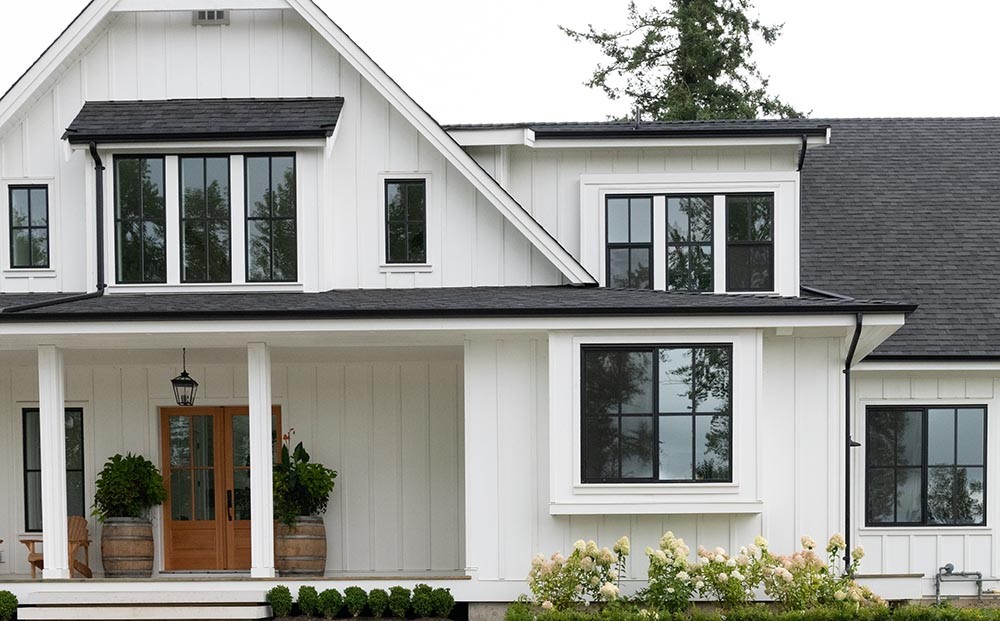 white house with black trim and wood accents 